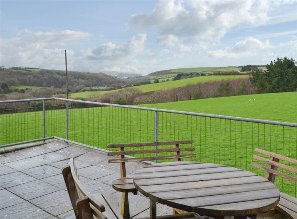 Paved patio with table and chairs to admire the landscape at Porth View in St Mawgan, near Newquay, Cornwall