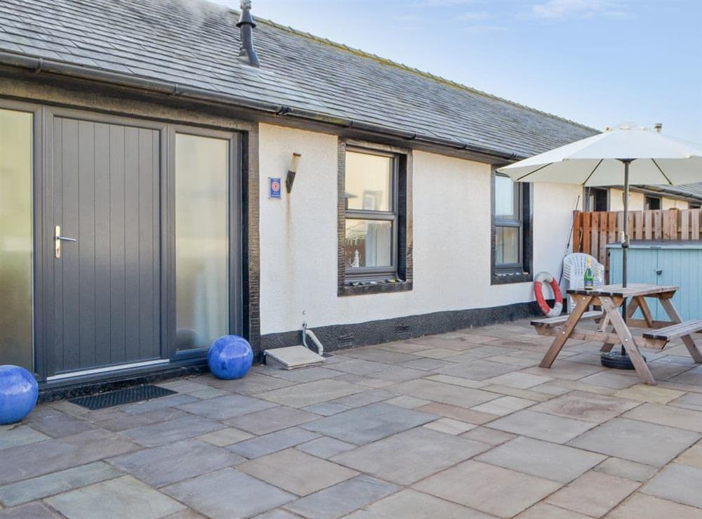 Paved patio area with outdoor furniture (photo 2) at Porthole Cottage in Allonby, near Maryport, Cumbria