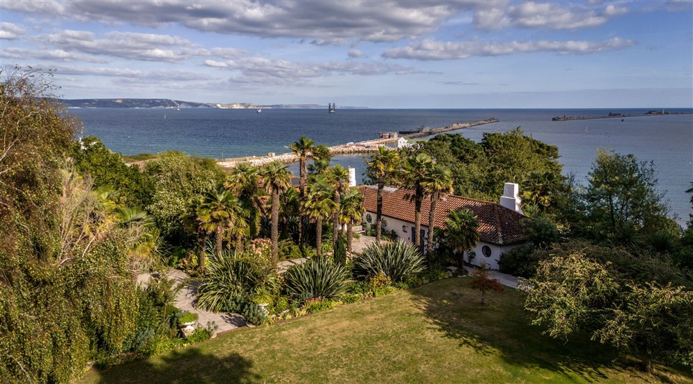 An aerial view of Portland House, its garden, the harbour and the Jurassic Coast in the distance, Dorset at Portland House in Weymouth, Dorset
