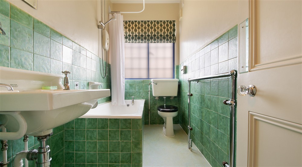 One of the bathrooms on the first floor of Portland House, with shower over bath, Dorset at Portland House in Weymouth, Dorset
