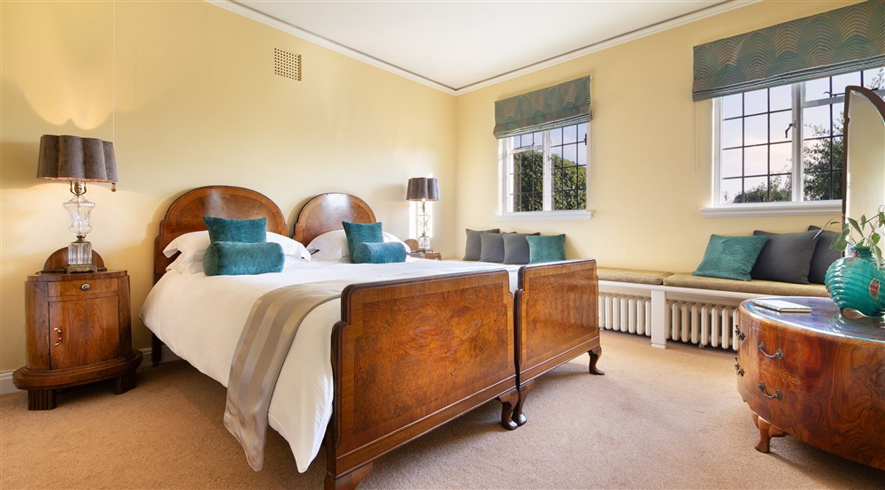One of the double bedrooms on the first floor of Portland House, with bench seating below the windows, Dorset at Portland House in Weymouth, Dorset