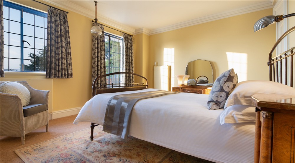 One of the double bedrooms on the first floor of Portland House, with patio doors to the upper terrace, Dorset at Portland House in Weymouth, Dorset