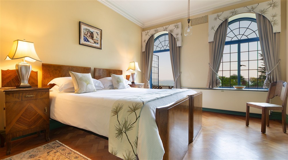 One of the double bedrooms on the ground floor of Portland House, with a connecting door to the next double bedroom and external door to the lower terrace, Dorset at Portland House in Weymouth, Dorset