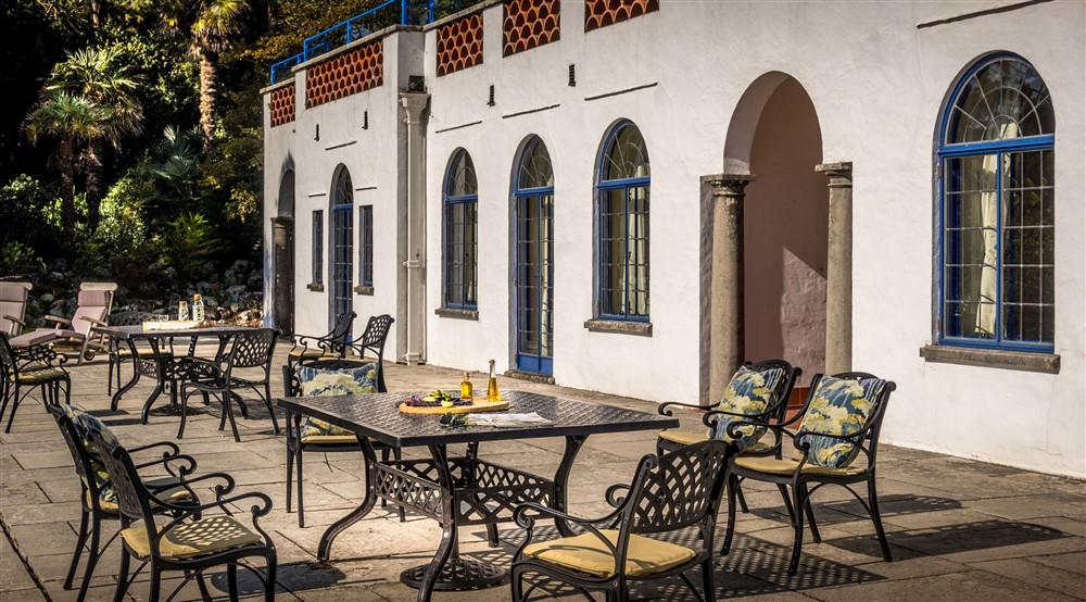 The lower terrace, with outdoor dining furniture, at Portland House in Weymouth, Dorset