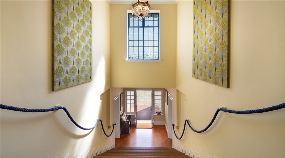 The main staircase and ground floor hall at Portland House in Weymouth, Dorset