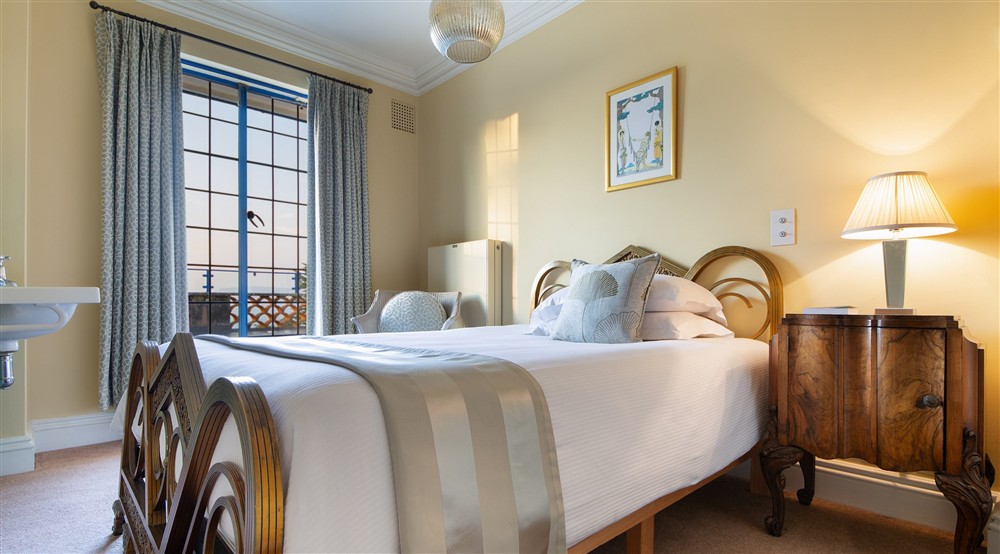 The single bedroom on the first floor of Portland House, with patio door to the upper terrace, Dorset at Portland House in Weymouth, Dorset