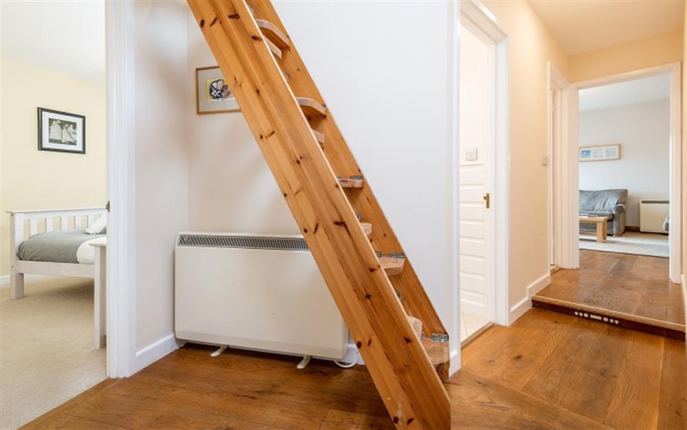 The loft ladder in the hall can be folded and bolted to the wall when not in use. at Portscatho in Helford Passage