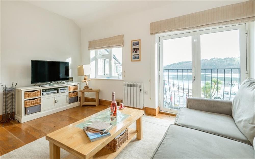 The stylish lounge is decorated in light colours, giving it a light and airy feel. Lovely views of the river from the french doors which open out to a Juliette balcony. at Portscatho in Helford Passage