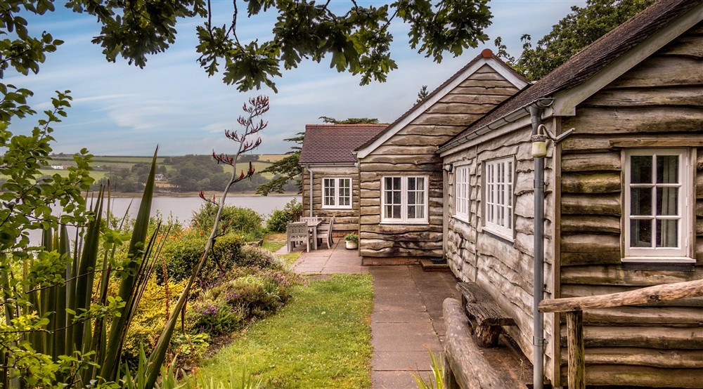 The exterior of Powders and its garden, with the Helford River in the background, Cornwall at Powders in Helston, Cornwall