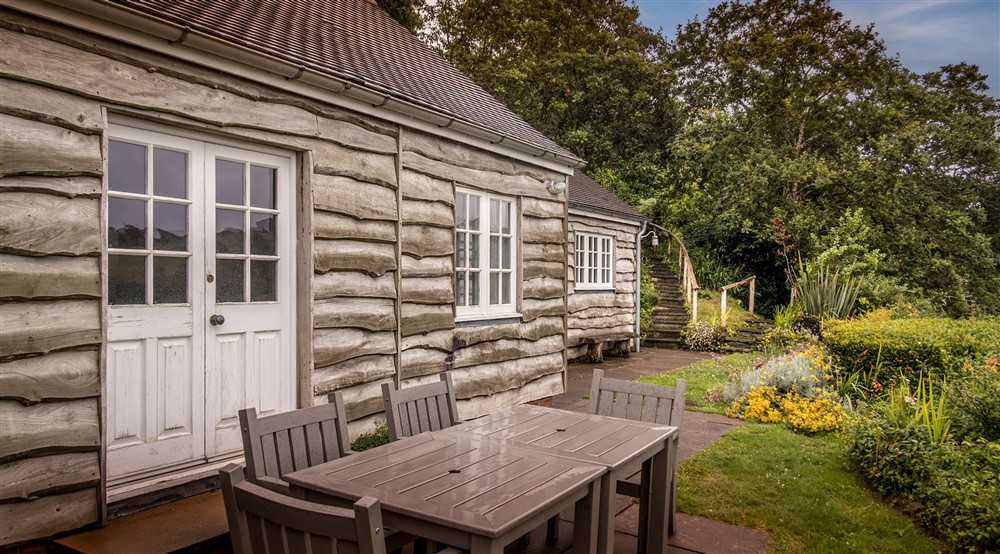 The garden patio of Powders, with outdoor dining furniture, Cornwall at Powders in Helston, Cornwall