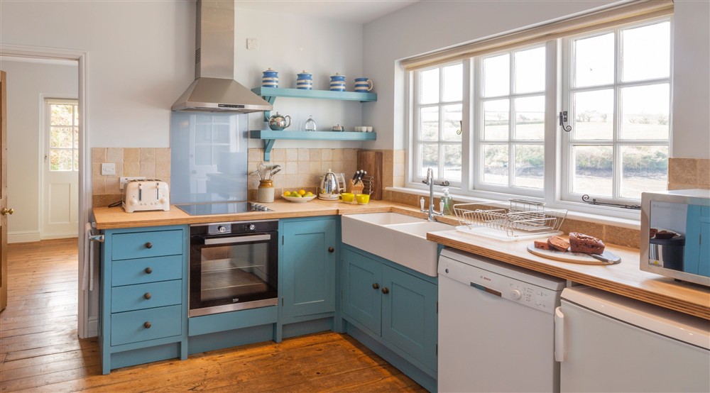 The kitchen has views across the water at Powders in Helston, Cornwall