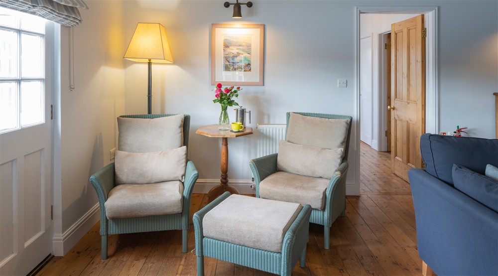 Wicker armchairs in the sitting room at Powders in Helston, Cornwall