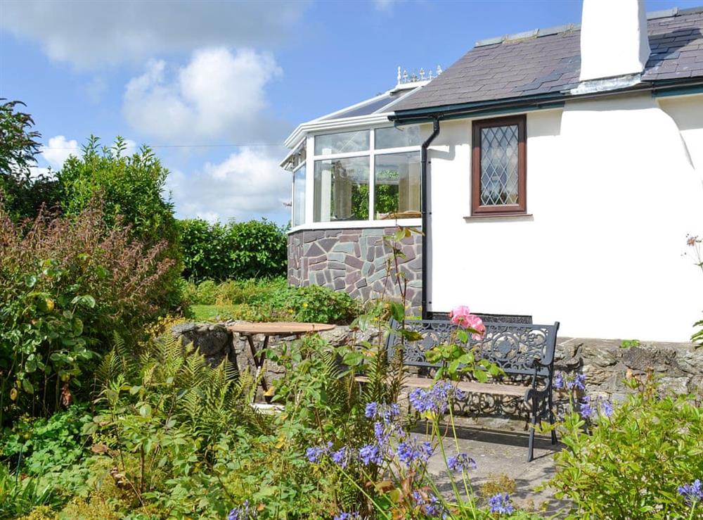 Well-maintained garden areas and patios at Preswylfa in Llanddona, near Bangor, Anglesey, Gwynedd