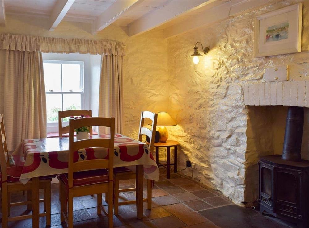 Dining room with wood burner at Preswylfa in Trefin, near St Davids, Dyfed