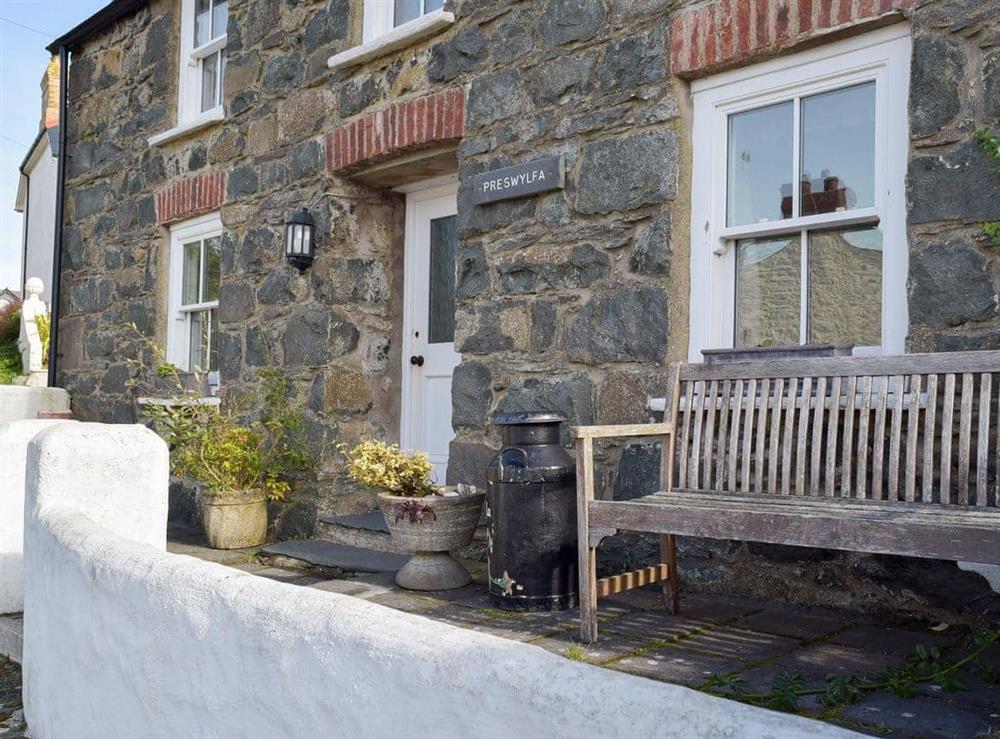 Small enclosed courtyard with sitting-out area and garden furniture at Preswylfa in Trefin, near St Davids, Dyfed