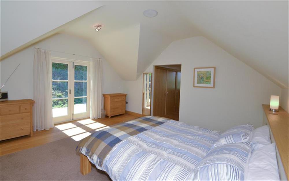 The Master bedroom on first floor, leading to the dressing area and en suite shower room at Primrose Bank in Hope Cove