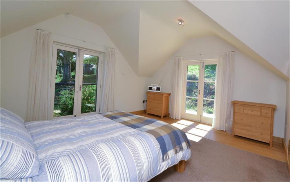 The Master bedroom, with Juliet balcony and french doors at Primrose Bank in Hope Cove