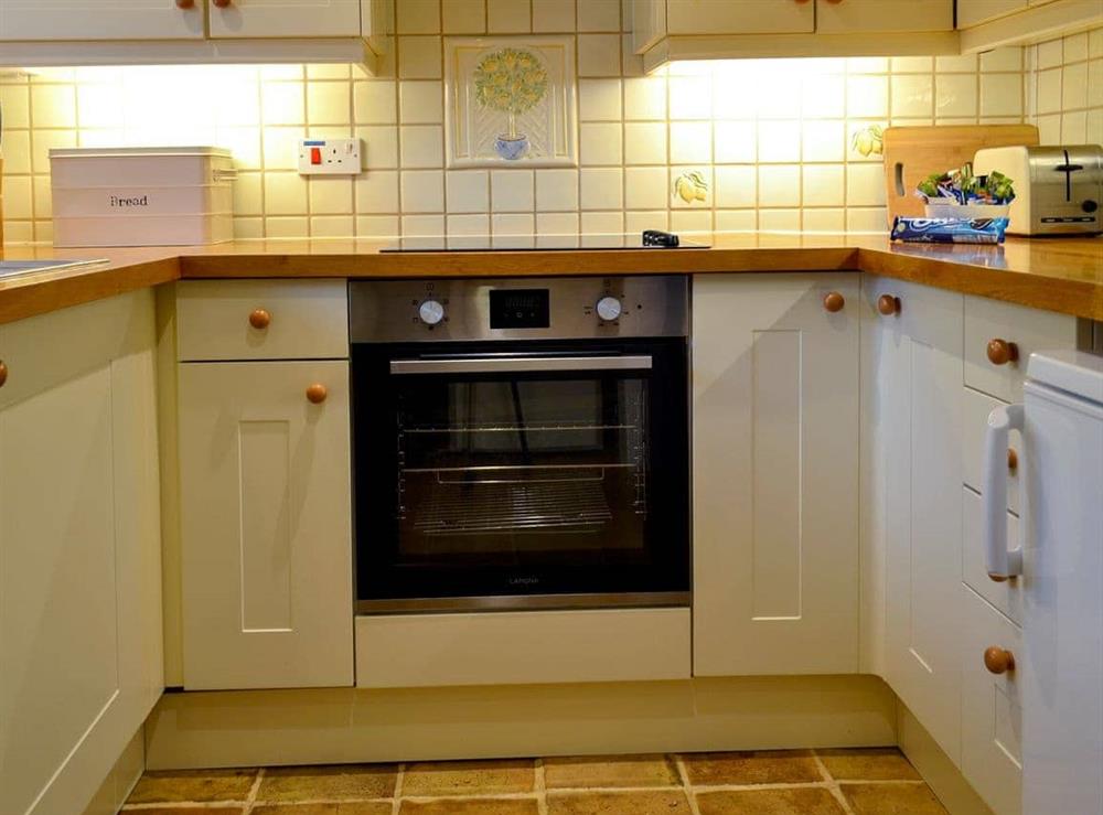 Well-equipped fitted kitchen at Primrose Cottage in Gresham, Norfolk, Great Britain