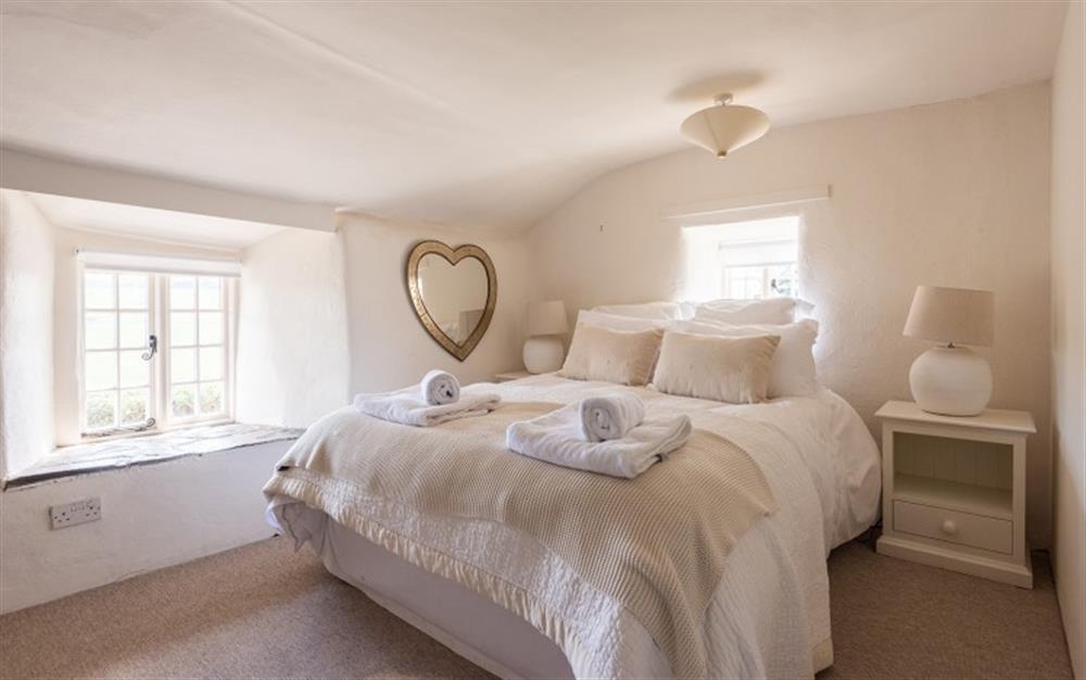 The comfortable master bedroom  at Primrose Cottage in Hope Cove