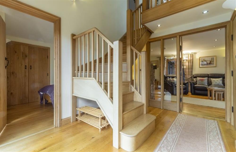 Ground floor: Entrance hall to bedroom four with wide entrance door at Princes Barn, Neatishead near Great Yarmouth
