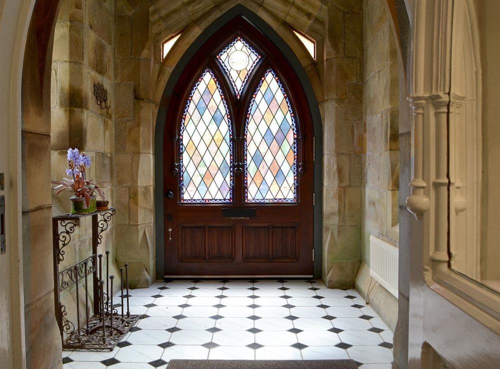 Impressive Gothic entrance with stained glass windows at Priory Manor in Windermere, Cumbria