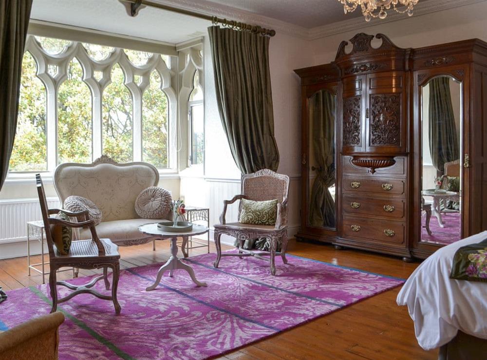 Lovely, spacious master bedroom with seating area at Priory Manor in Windermere, Cumbria