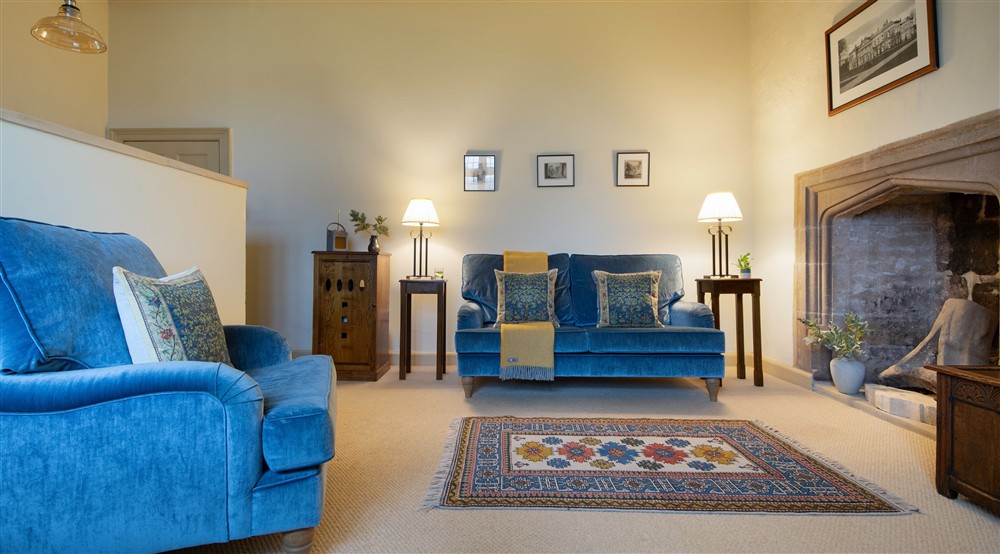 The sitting area with sofa, armchair and fireplace at Proctor in Ripon, North Yorkshire