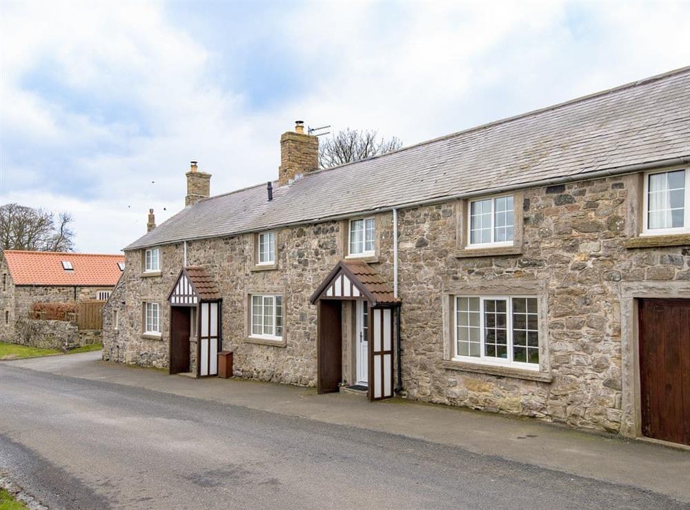 Attractive end-terrace stone-built holiday home on left of picture at Dunstanburgh View, 