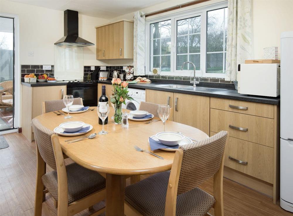 Well-equipped kitchen with dining area at Dunstanburgh View, 