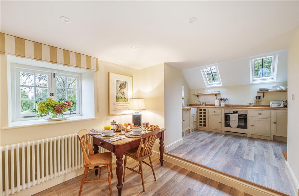 The dining area and step up to the kitchen at Puddle Cottage, Dorchester