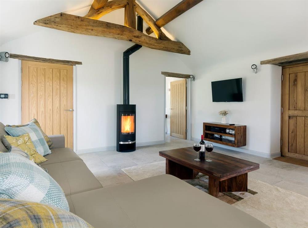Thoughtfully renovated living room area with wood burner at Puddledock Piggery in Berkley, near Frome, Somerset