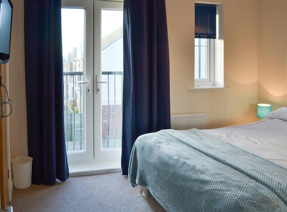 Double bedroom with Juliette balcony at Puffin Place in Beadnell, near Alnwick, Northumberland
