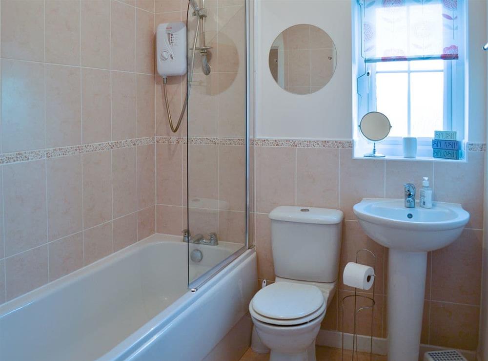 House bathroom with shower over bath at Puffin Place in Beadnell, near Alnwick, Northumberland