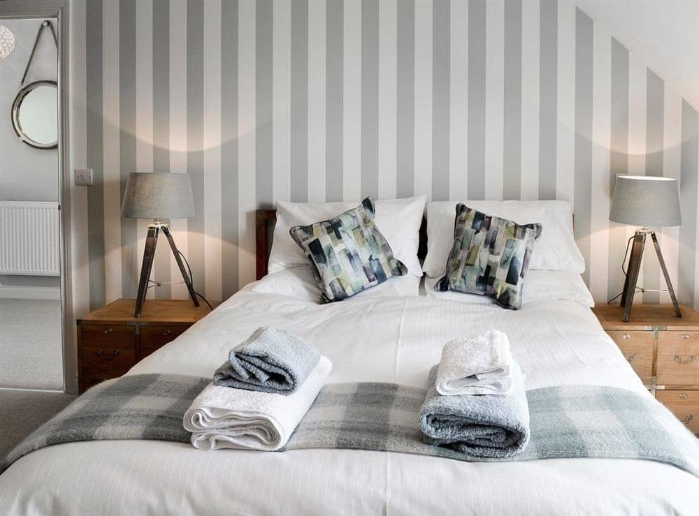 Relaxing bedroom with king-size bed and en-suite at Puffins in Beadnell, near Alnwick, Northumberland