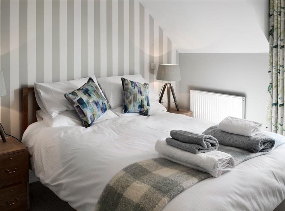 Stunning bedroom with king-size bed at Puffins in Beadnell, near Alnwick, Northumberland