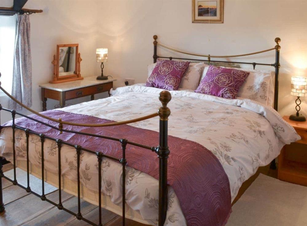 Lovely and romantic double bedroom with antique style bed at Purlinney in Trebarwith, Delabole., Cornwall