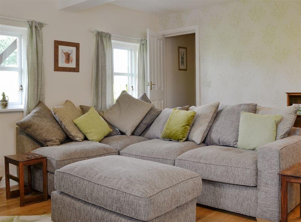 Plush sofa at Pussywillow Cottage in Rowrah, near Cockermouth, Cumbria
