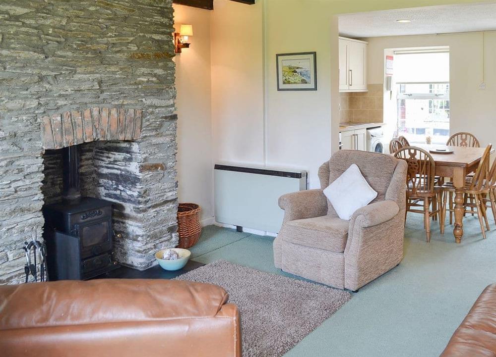Living area with feature fireplace at Quarrymans Cottage in Edmonton, near Wadebridge, Cornwall