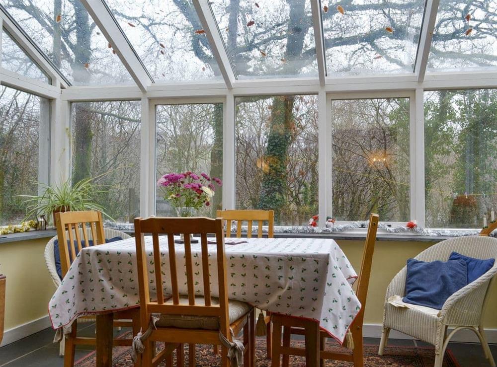 Light and airy conservatory with dining area at Quarrymans Cottage in Golberdon, Nr Callington, Cornwall., Great Britain