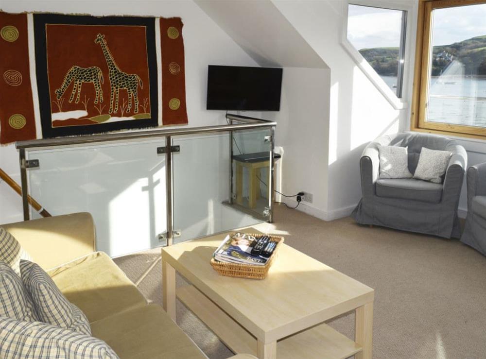 Feature vaulted sitting room with large picture window at Quays Cottage in Salcombe, Devon