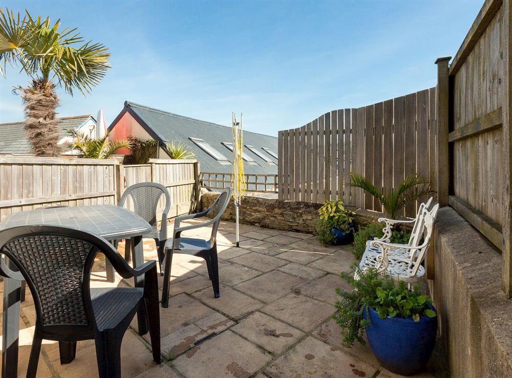 Flagged courtyard with outdoor furniture, BBQ and right of access to steps down to Victoria Quay at Quays Cottage in Salcombe, Devon