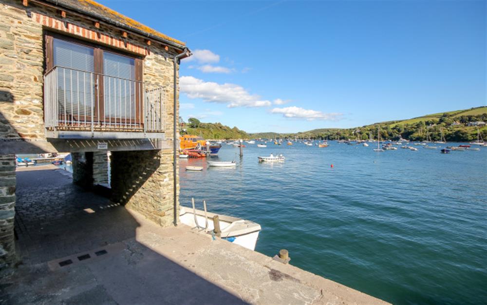 A look at the exterior and lounge balcony at Quayside Cottage in Salcombe