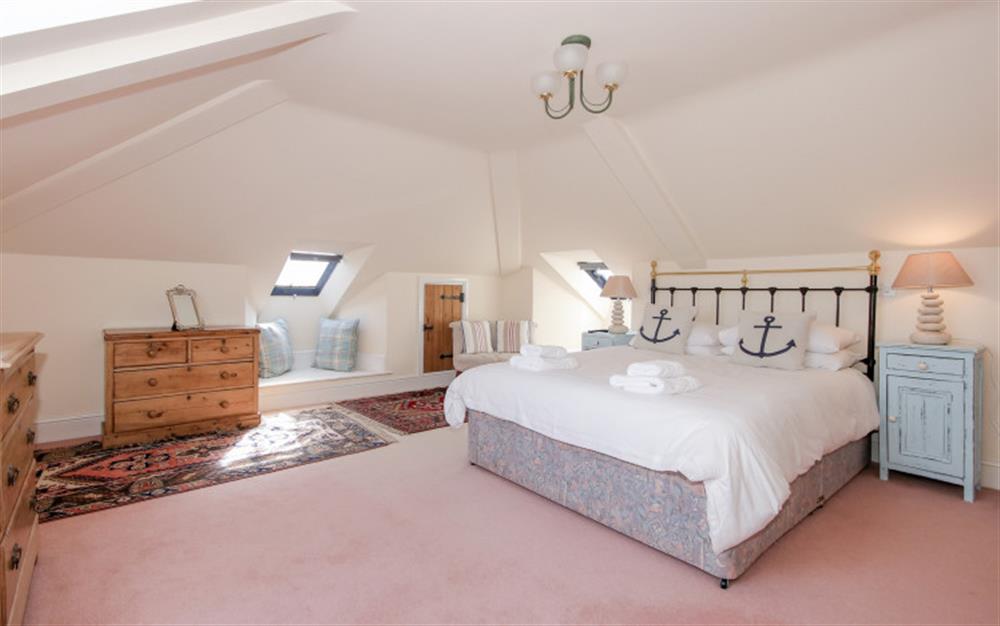 Bedroom 1 with king bed, TV and en suite shower room at Quayside Cottage in Salcombe