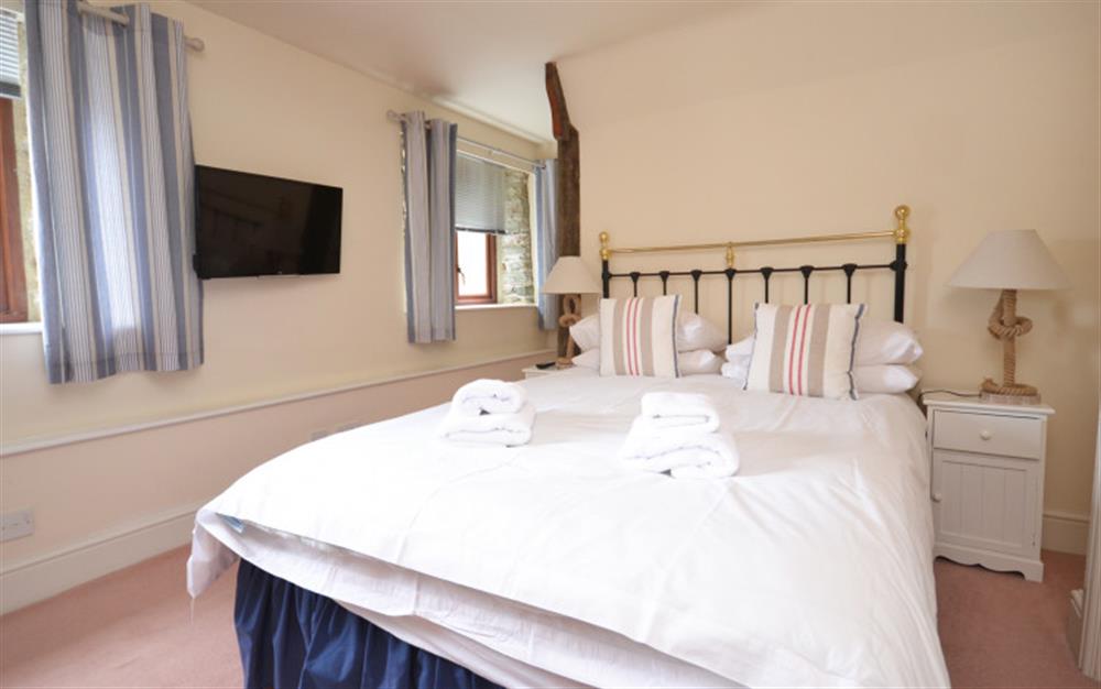 Bedroom 2 with double bed, TV and en suite shower room at Quayside Cottage in Salcombe