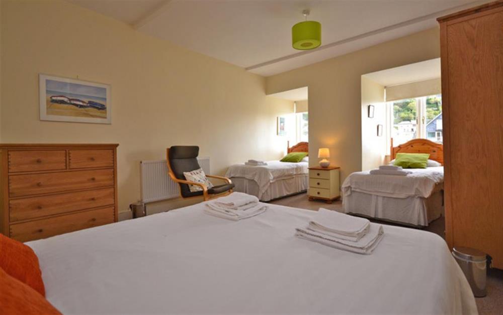 The large family bedroom with one double and two single beds. at Quayside Flat in Looe