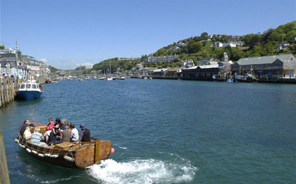The little ferry that plies between East and West Looe at high tide at Quayside Flat in Looe
