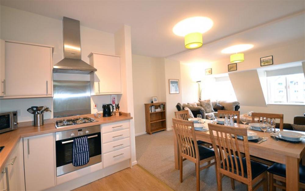 The open plan kitchen/diner through to the lounge at Quayside Flat in Looe