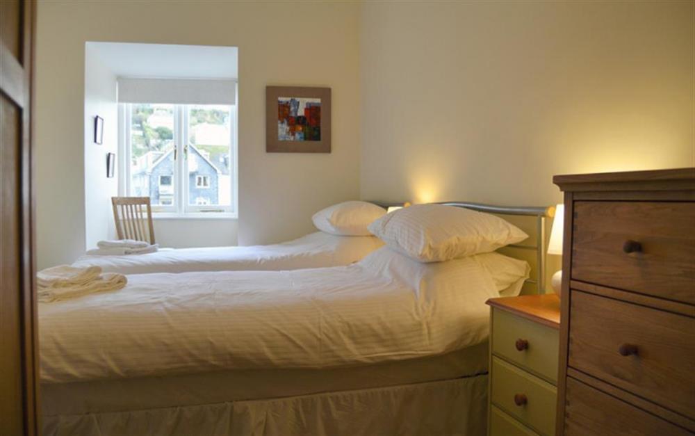The twin bedroom, with harbour views at Quayside Flat in Looe
