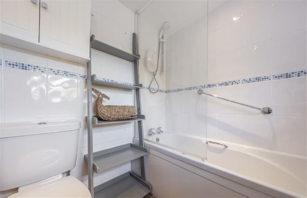 Bathroom with bath with overhead shower at Queenie’s Cottage, Wells-next-the-Sea