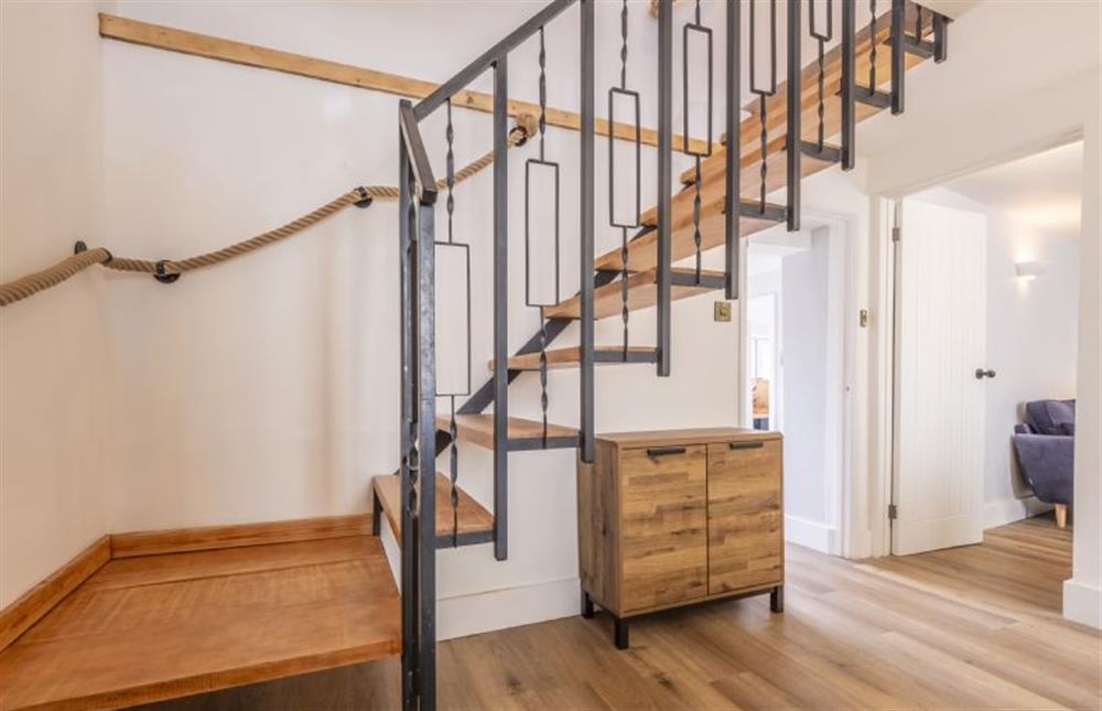 Open stairs with handrails lead to the first floor at Queenie’s Cottage, Wells-next-the-Sea
